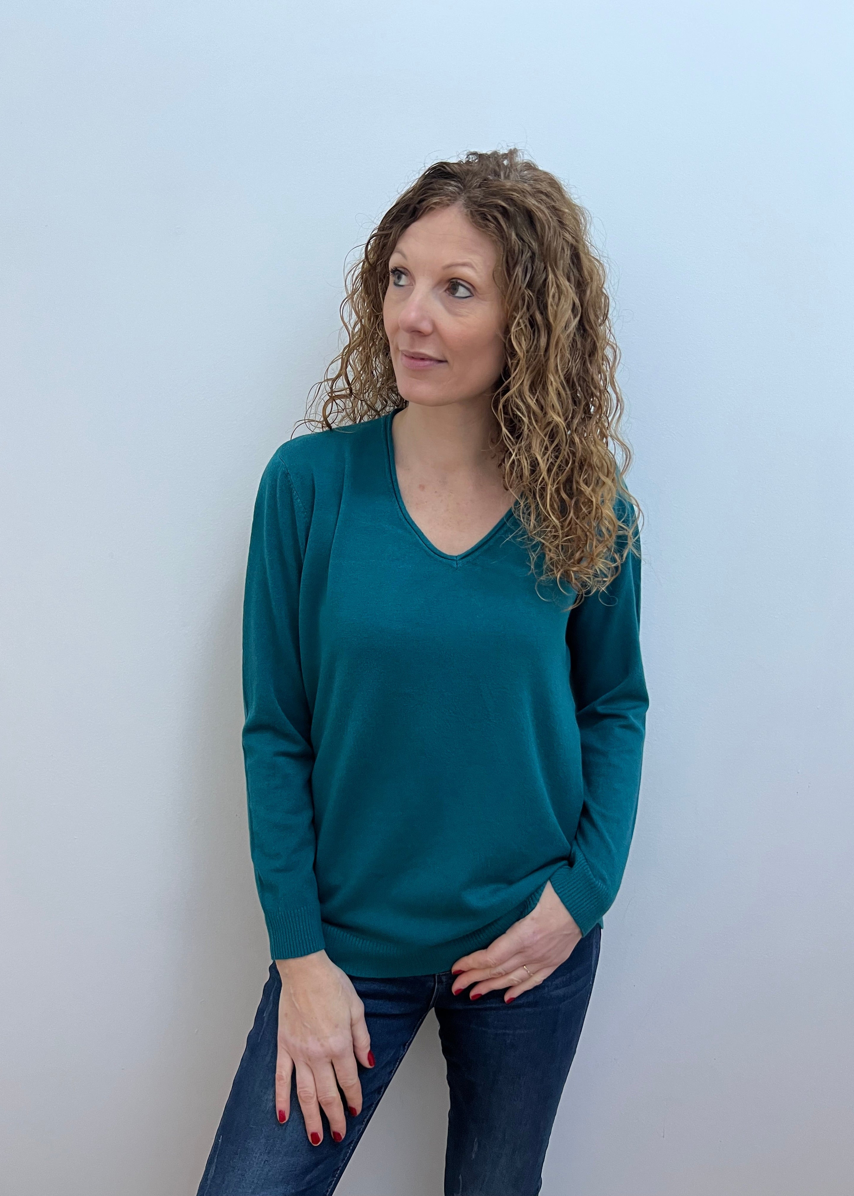 Woman wearing a green V-neck jumper