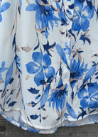 White shirt with blue floral pattern on a wooden surface