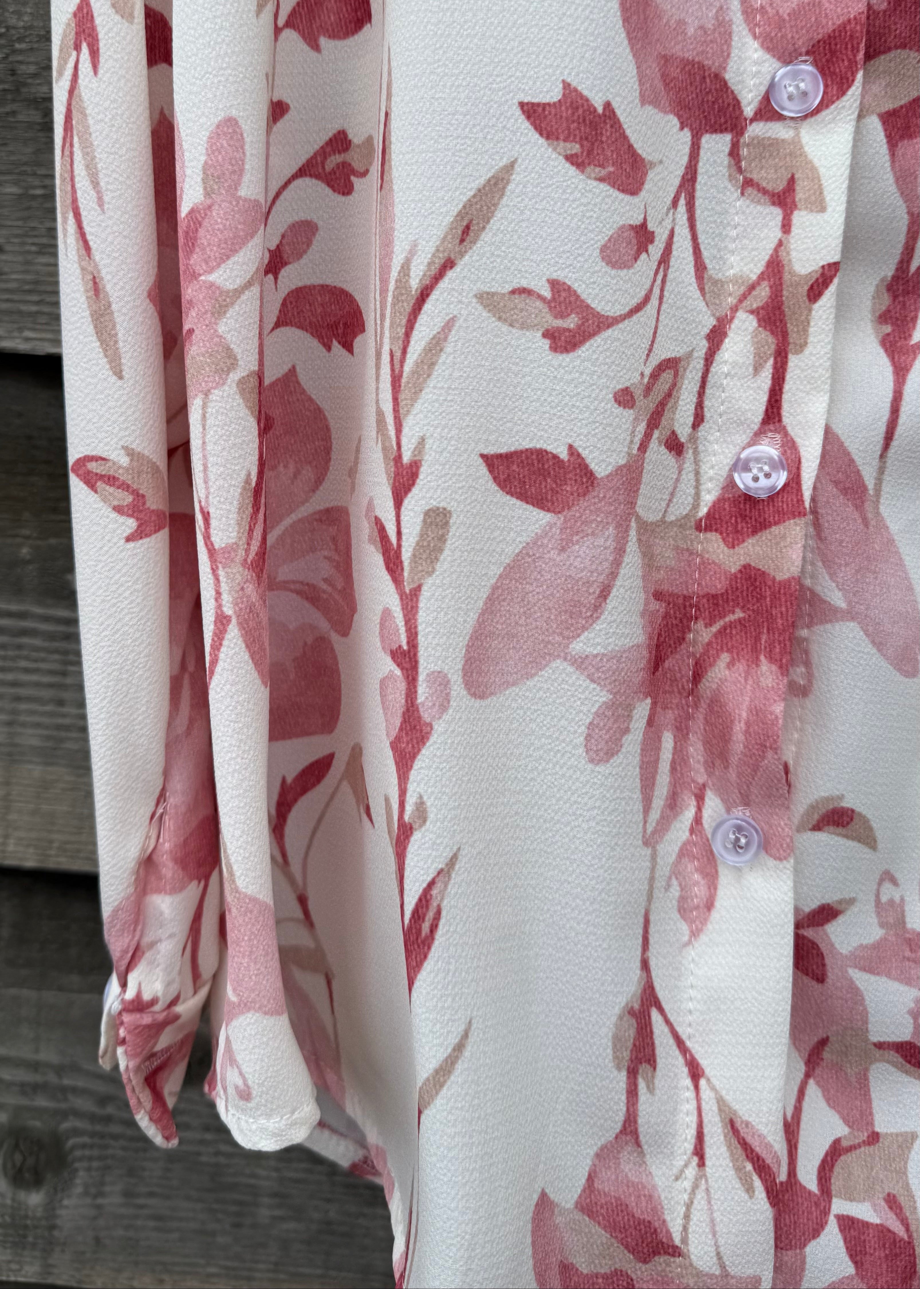 Floral patterned fabric with red and pink flowers on a white background
