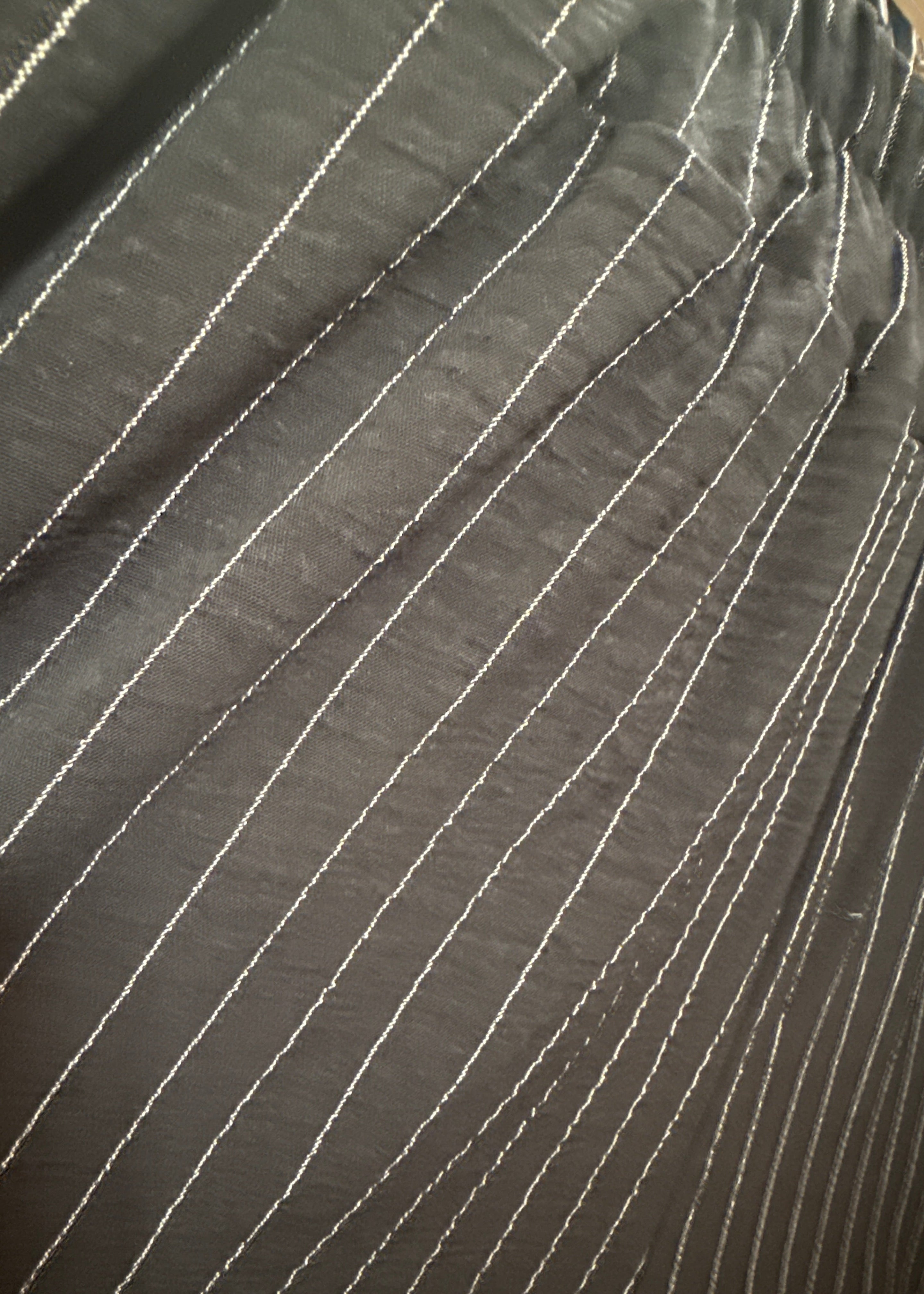 Close-up of black fabric with white stitching