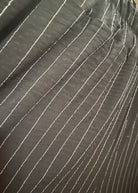 Close-up of black fabric with white stitching