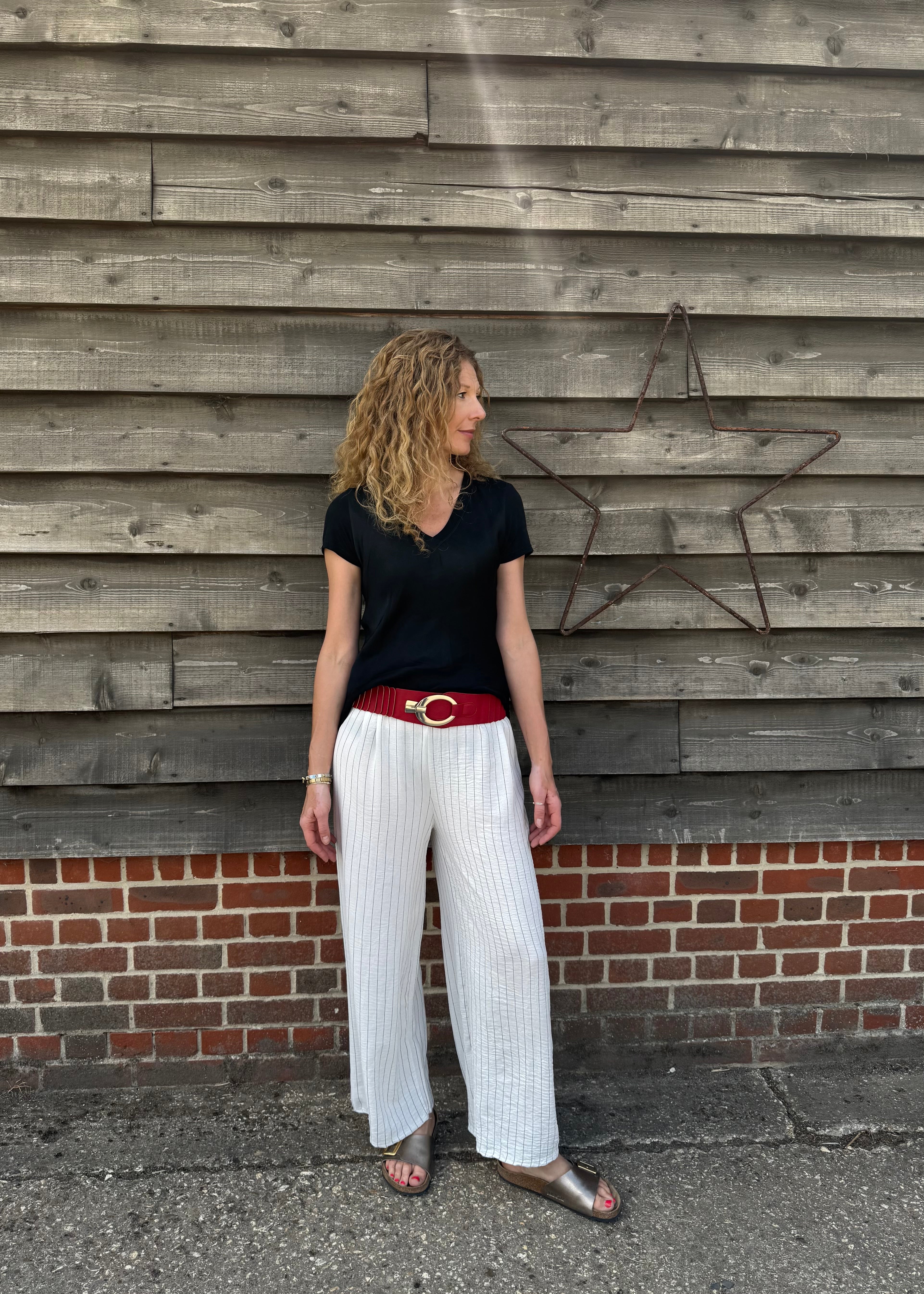 Woman standing against a wooden wall with a star decoration