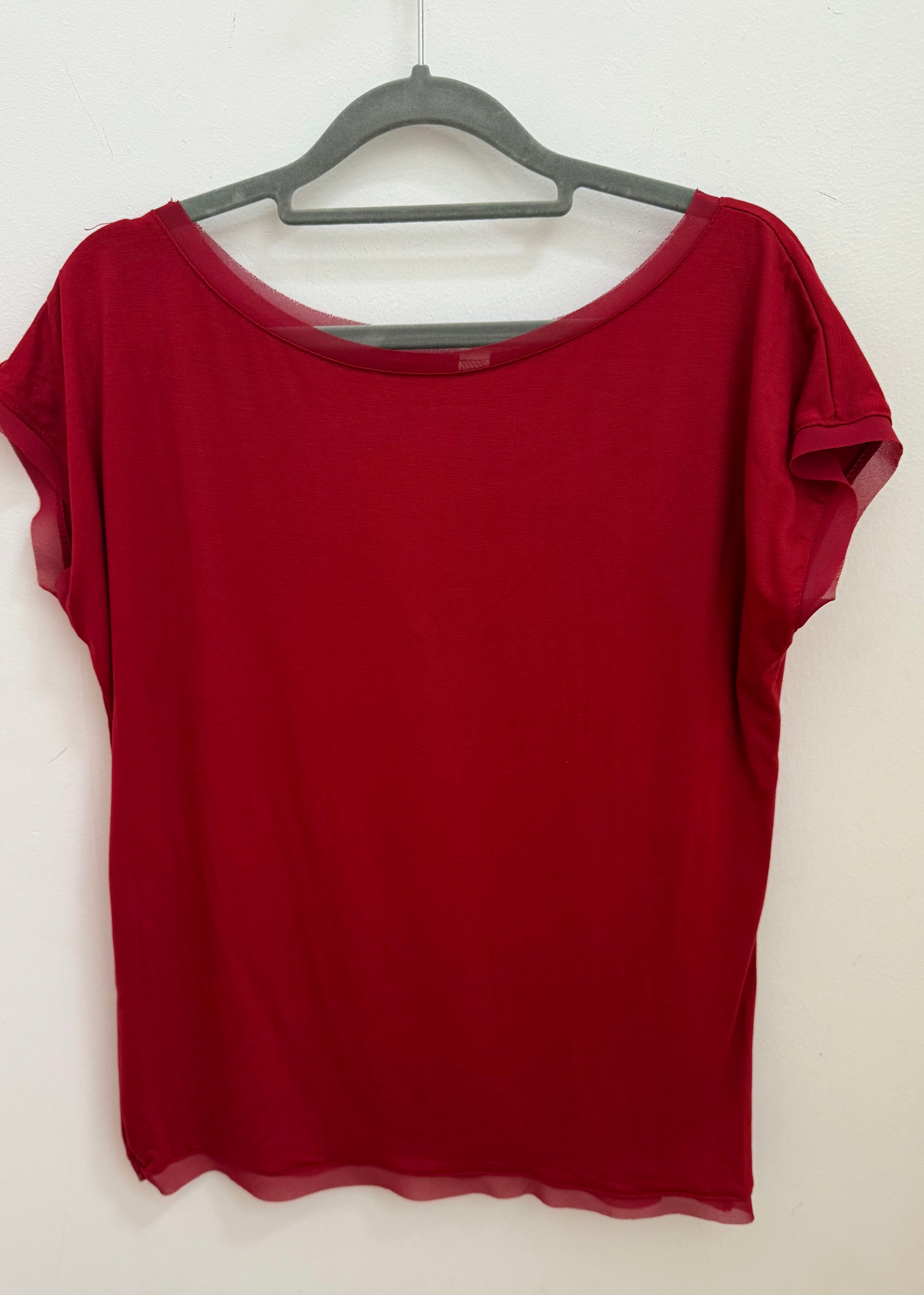 Red t-shirt on a hanger against a white background